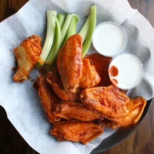 a plate of wings and celery