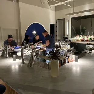 a group of people sitting at a bar