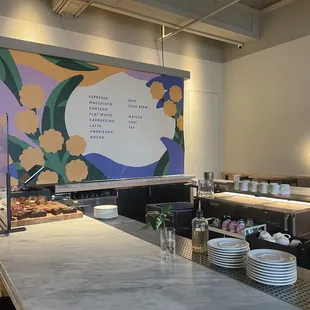 a restaurant counter with plates of food on it
