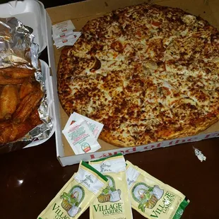 a box of chicken wings and a pizza