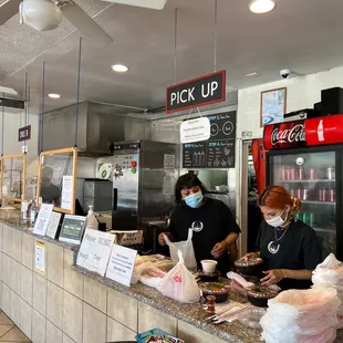a man and a woman standing at a counter