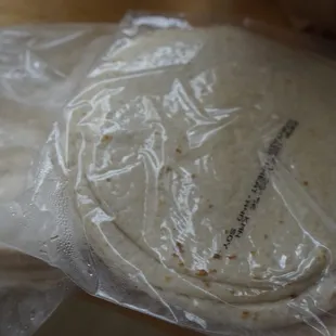a tortilla wrapped in plastic wrap