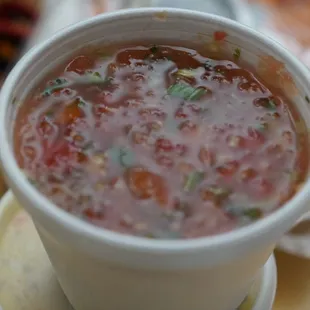 a cup of soup on a plate