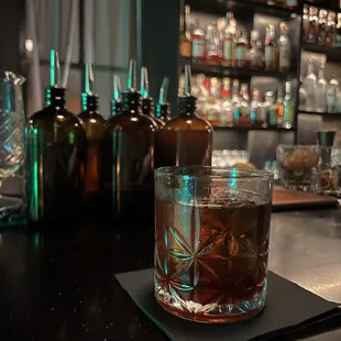 a glass of whiskey on a coaster