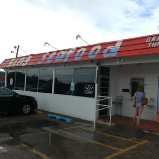 a woman standing in front of a restaurant
