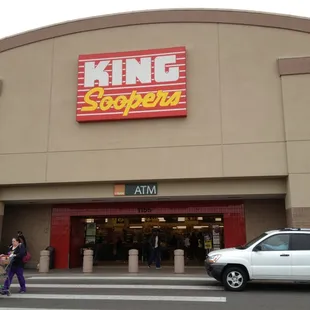 a woman pushing a shopping cart in front of a store