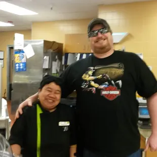 a man and a woman standing in a kitchen