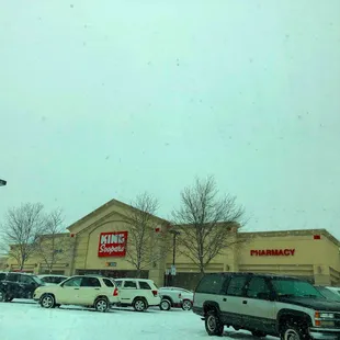 cars parked in front of a pharmacy