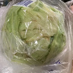 a head of lettuce wrapped in plastic
