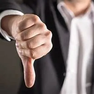 a man in a suit pointing at the camera