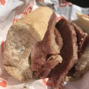Corned beef sandwich featuring molded bread and visibly dry meat. I was sharing this with someone who took a bite of the other side