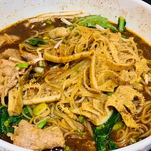 a bowl of noodles with meat and vegetables