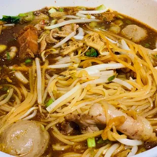 a bowl of noodles with meat and vegetables