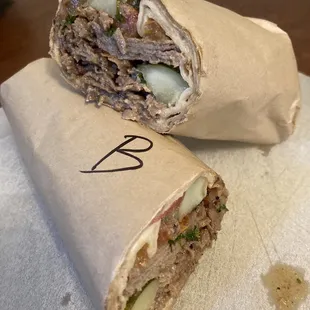 Tut wrap (beef shawerma): seasoned grilled beef strips with parsley, pickles, tomatoes &amp; onions