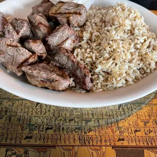 a plate of food with rice and meat