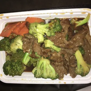 beef, broccoli and carrots in a styrofoam container