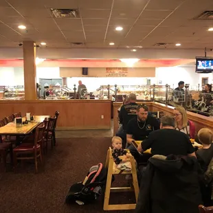 people sitting at tables and eating