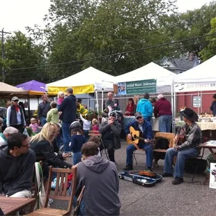 a large group of people sitting and standing