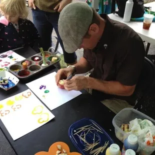 Erik Brown "Veggie Painting" with the kids at the Kingfield Farmers Market
