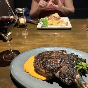 a plate of food and a glass of wine