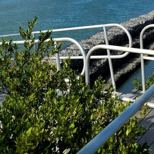a view of the ocean from the deck of a restaurant