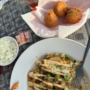 Cajun fish and shrimp with rice bowl and hush puppies