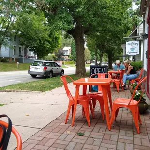 a woman sitting at a table outside