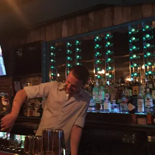 a bartender pouring a drink at a bar