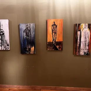 four paintings on a wall