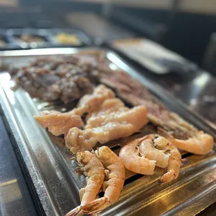 a tray of shrimp and meat