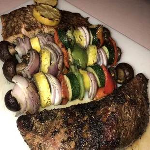 a steak and vegetables on a cutting board