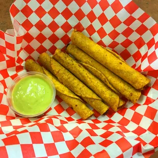 Quick bowling snack- beef taquitos and avocado sauce