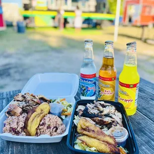 two trays of food on a picnic table