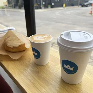 two cups of coffee and a bagel