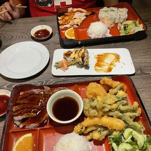 Two bento boxes n. 14 closest n. 7 farthest and in between spicy tuna tempura roll