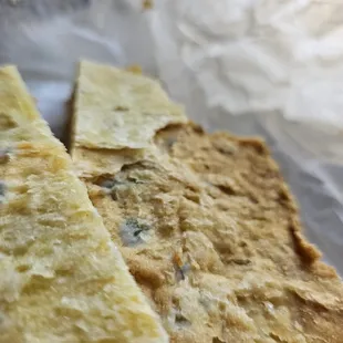 two quesadillas on a piece of wax paper