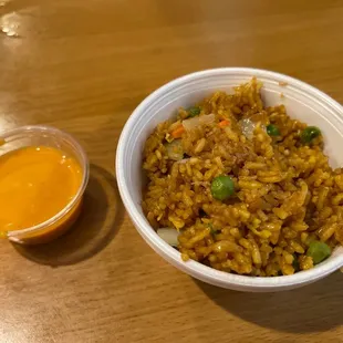 a bowl of fried rice and sauce