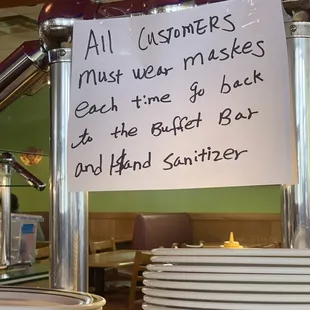 Sign and sanitizer at each buffet set up