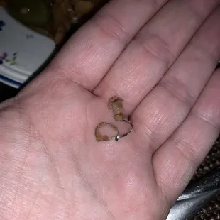 a hand holding a piece of food
