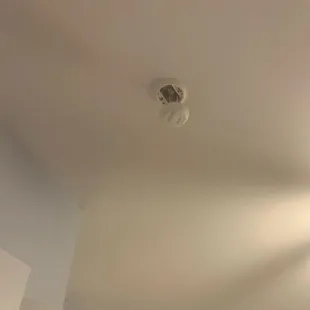 A fire alarm hanging in the main bedroom