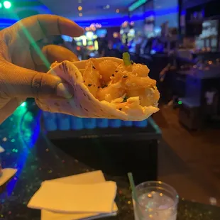 a hand holding a piece of food