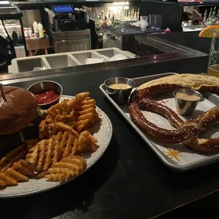 a pretzel sandwich and fries