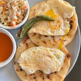 Incredible beans/cheese/carnitas pupusas with fried eggs on top (I cooked the eggs at home). The pepper is SPICY!