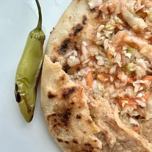 Carnitas, beans, and cheese pupusa. Comes with a jalapeño which is hot!