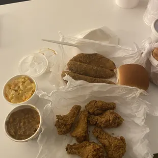 Fried chicken, macaroni, yams, potato wedges, roll, pink lemonade