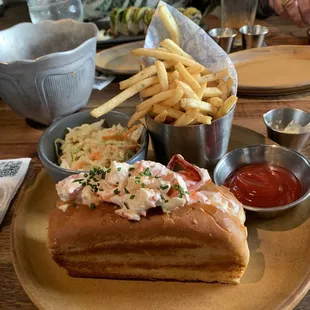 Lobster roll french fries and coleslaw over the top