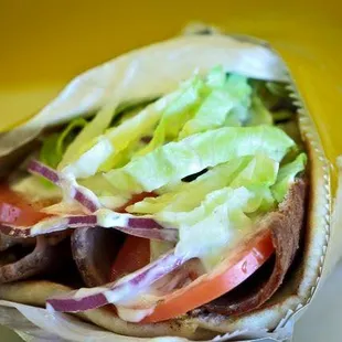 a wrap with lettuce and tomatoes