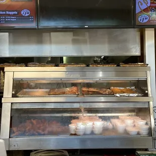 Hot food counter. Chicken seems to be their biggest selller and they keep it along with sides and biscuits here to fill orders.