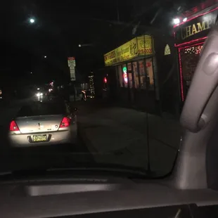 a car driving down a street at night