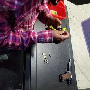 Wife loading the magazine of a .22
